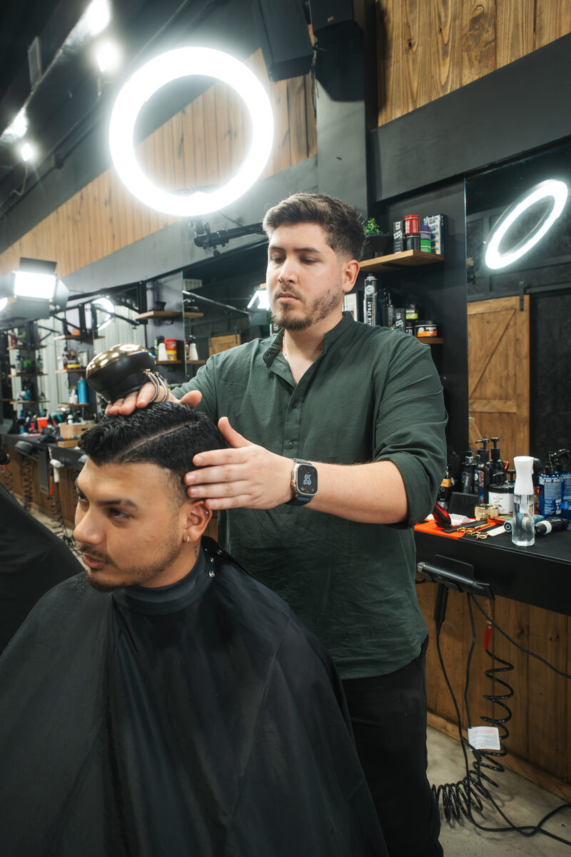 Willys Barber cutting hair at Capitano Barbershop